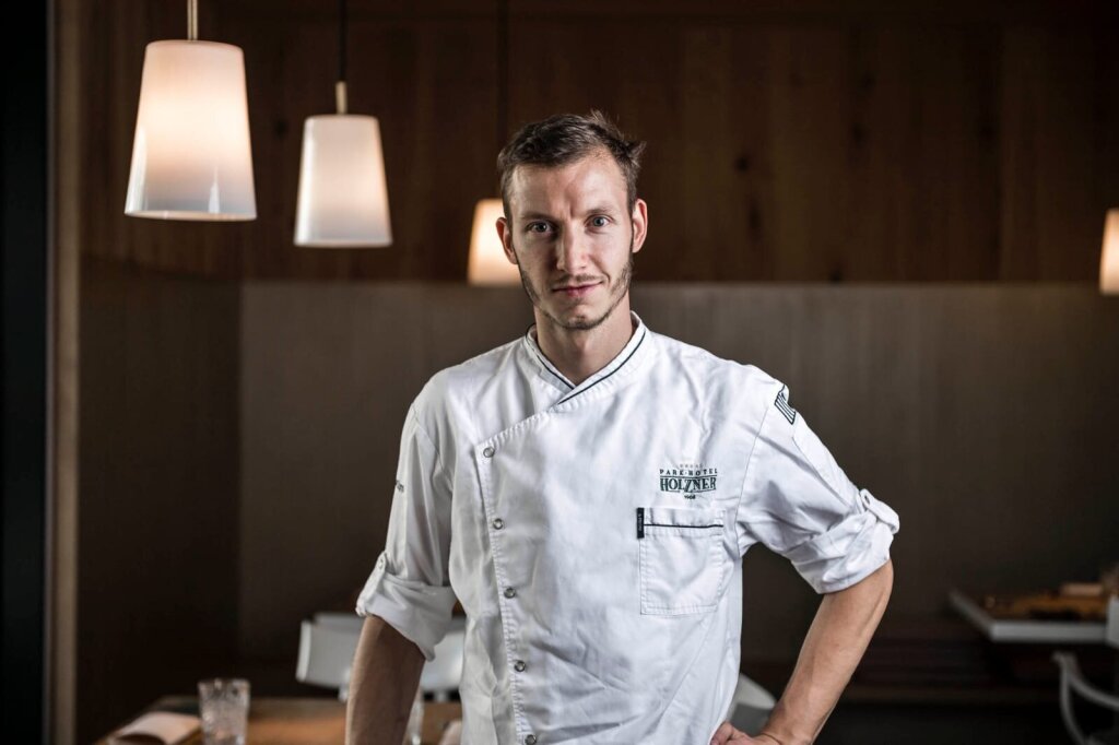 Stephan Zippl in a chef’s jacket in a restaurant.
